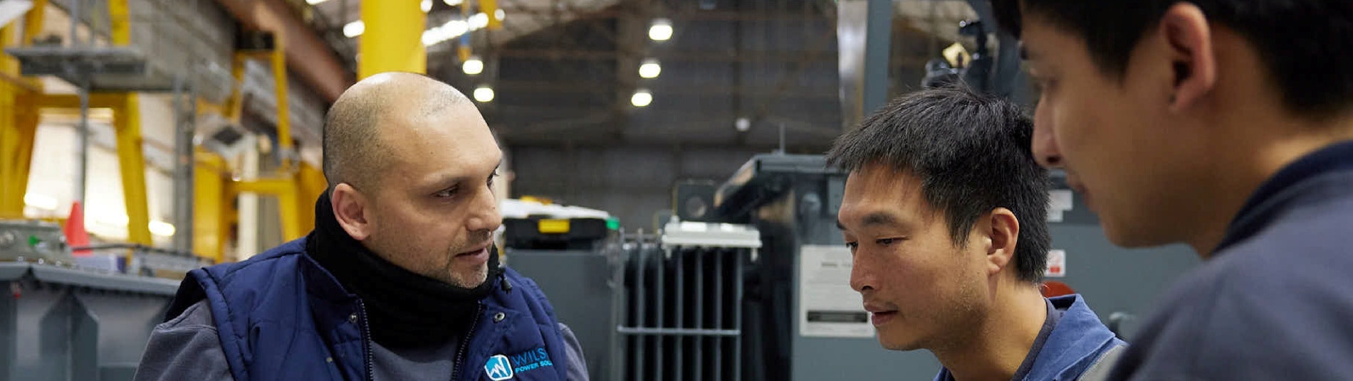 WPS staff talking in front of a transformer